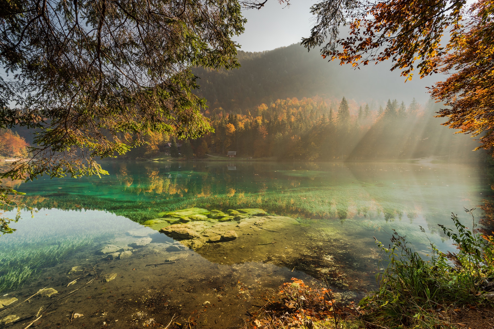 Clear water in Fusine lake with sunsine